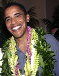 Obama, looking lei’d back